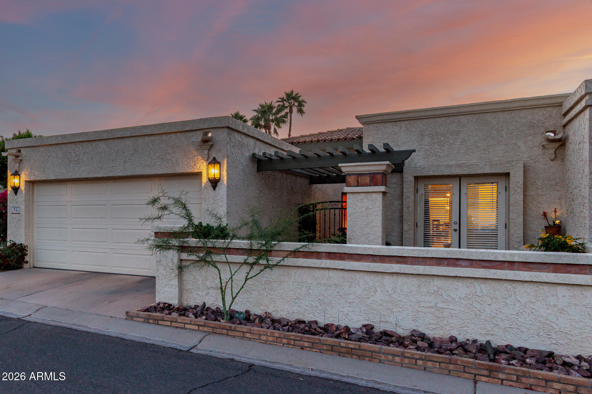 a front view of a house with sitting area