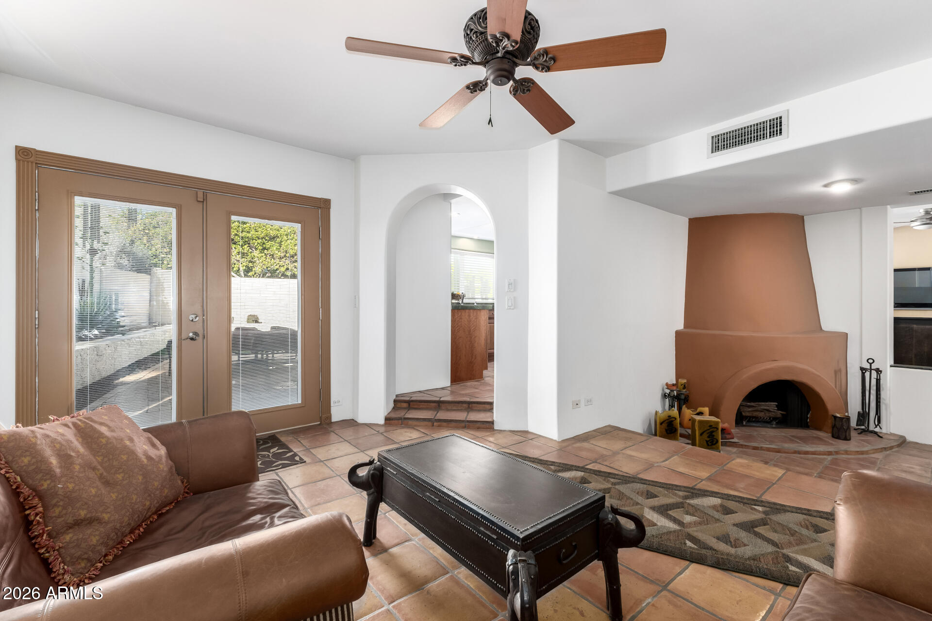 9012 South 47th Place Phoenix, AZ 85044 - Photo 13 of 54 a living room with furniture a fireplace and a table