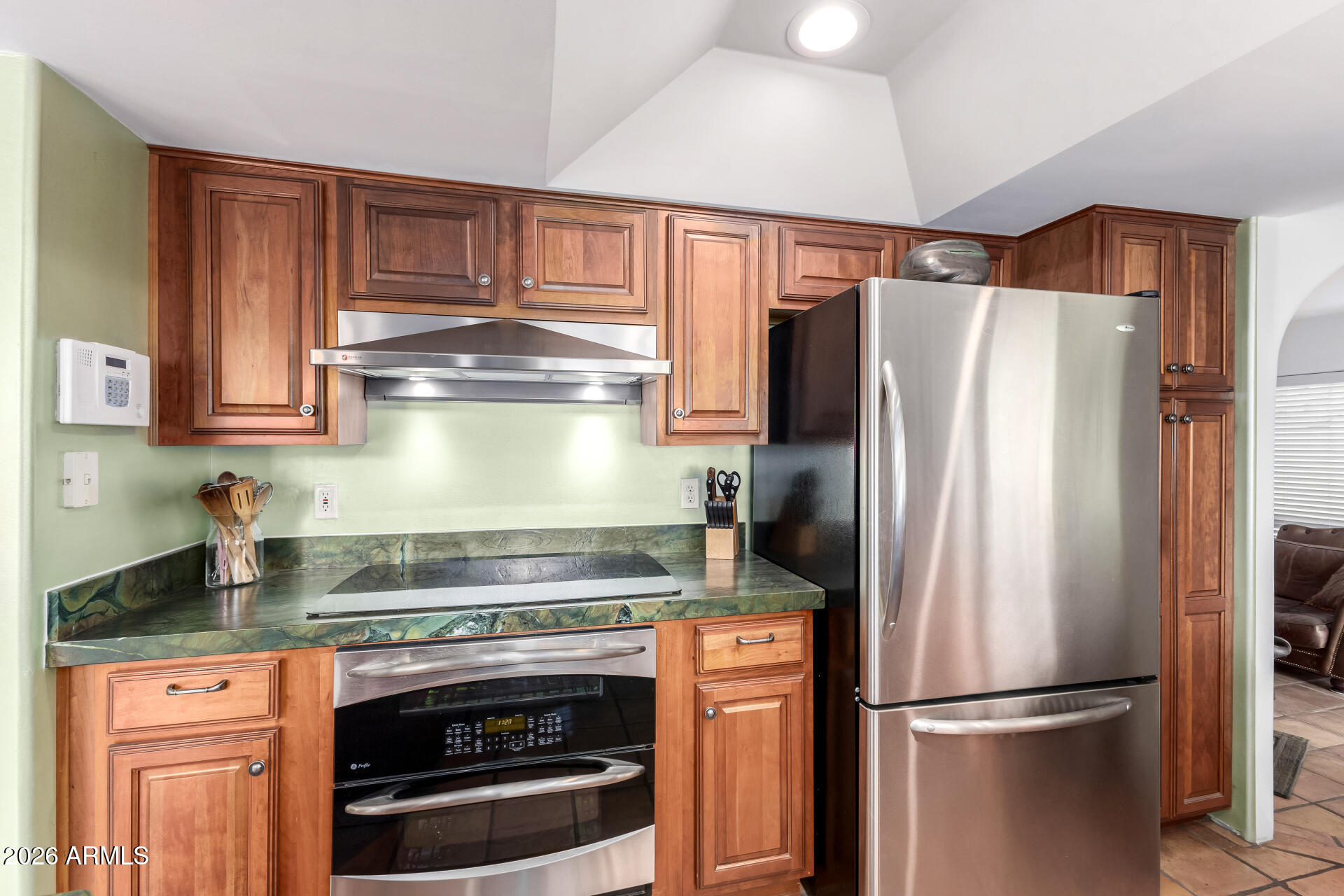 9012 South 47th Place Phoenix, AZ 85044 - Photo 22 of 54 a kitchen with granite countertop stainless steel appliances and wooden cabinets