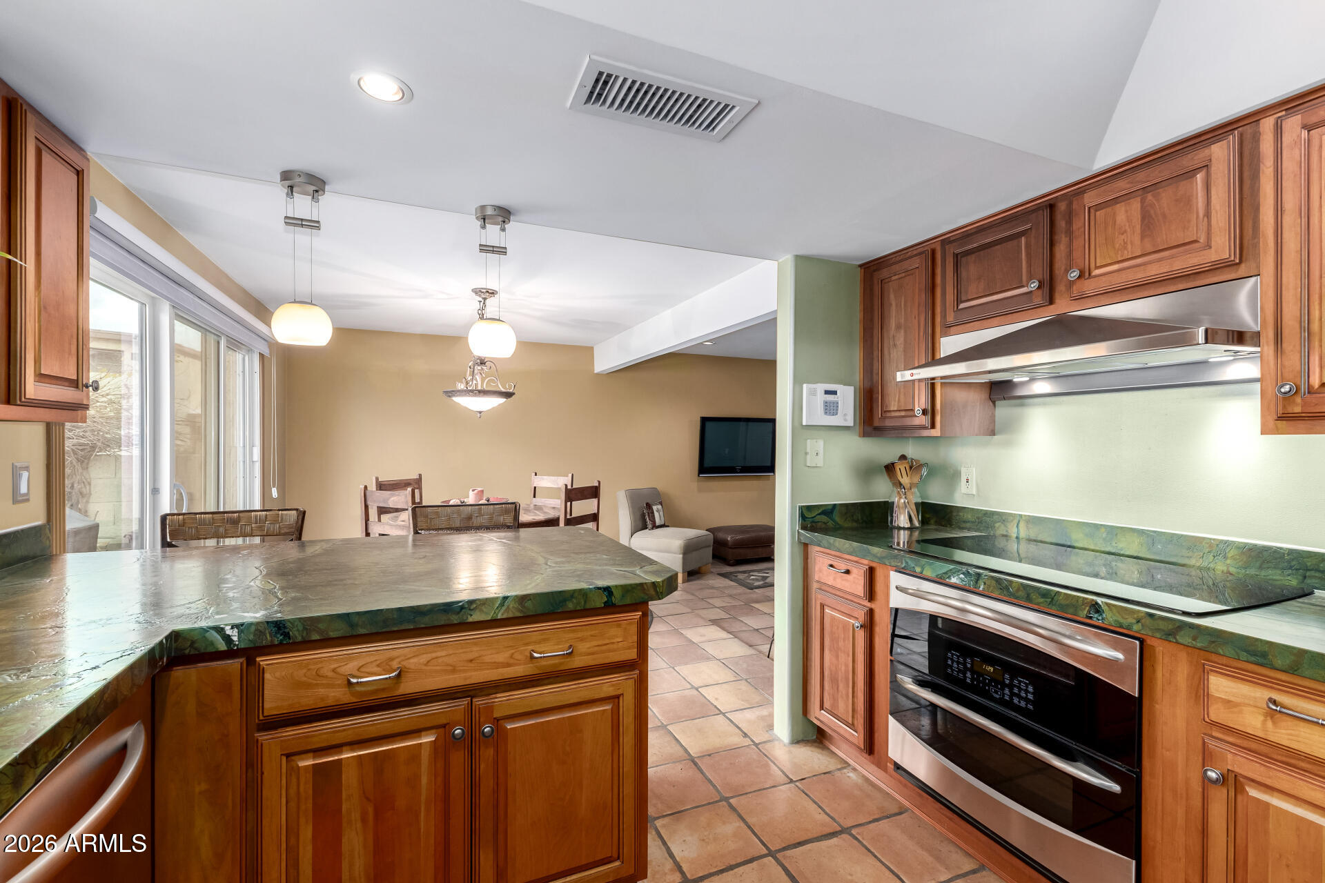 9012 South 47th Place Phoenix, AZ 85044 - Photo 23 of 54 a kitchen with stainless steel appliances granite countertop a stove and a sink