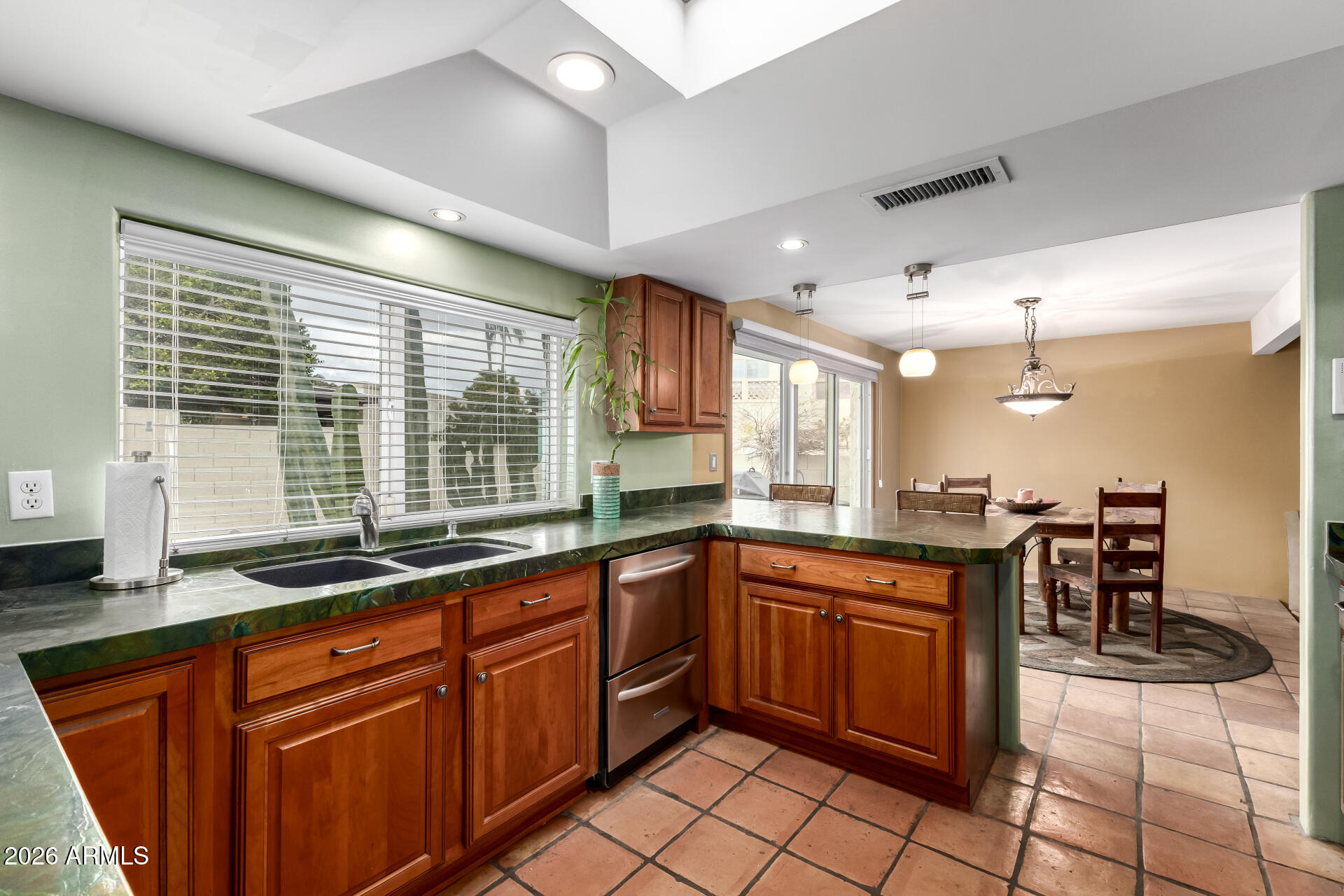 9012 South 47th Place Phoenix, AZ 85044 - Photo 24 of 54 a kitchen with lots of counter top space and dining table
