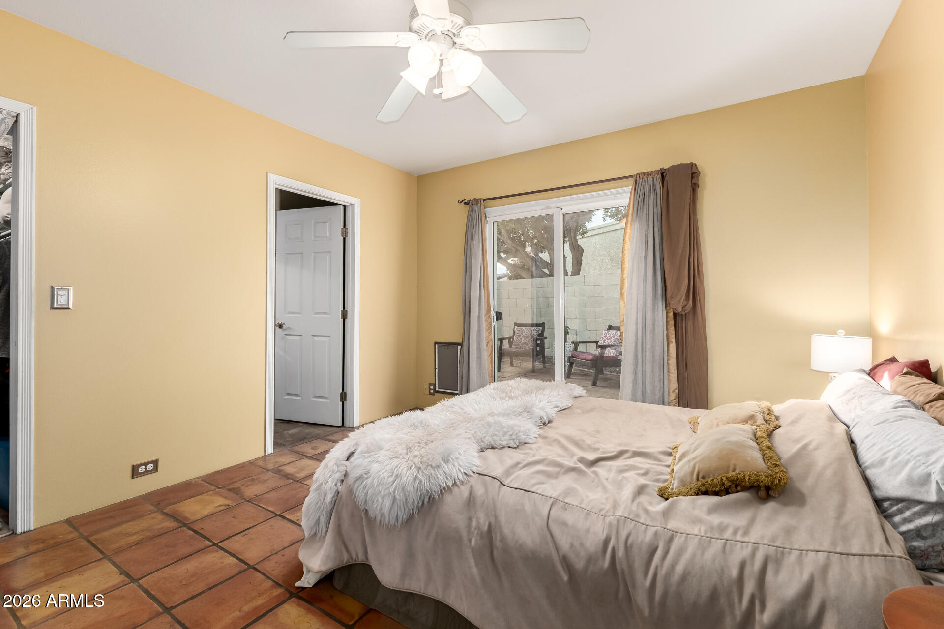 9012 South 47th Place Phoenix, AZ 85044 - Photo 25 of 54 a bedroom with a bed and a chandelier