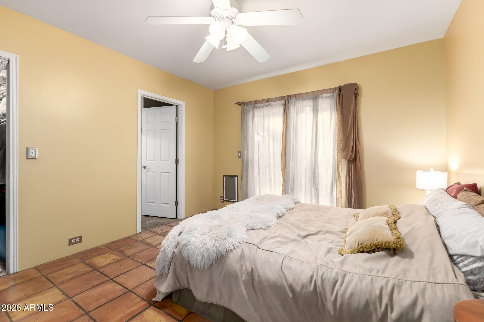 9012 South 47th Place Phoenix, AZ 85044 - Photo 26 of 54 a bedroom with a bed and a chandelier