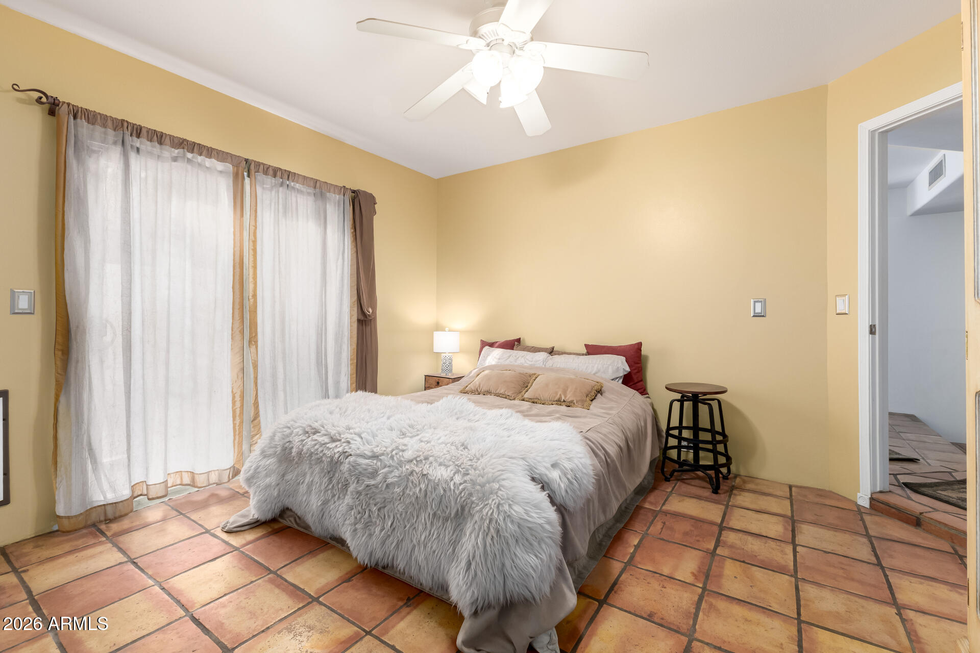 9012 South 47th Place Phoenix, AZ 85044 - Photo 27 of 54 a bedroom with a bed and a chandelier