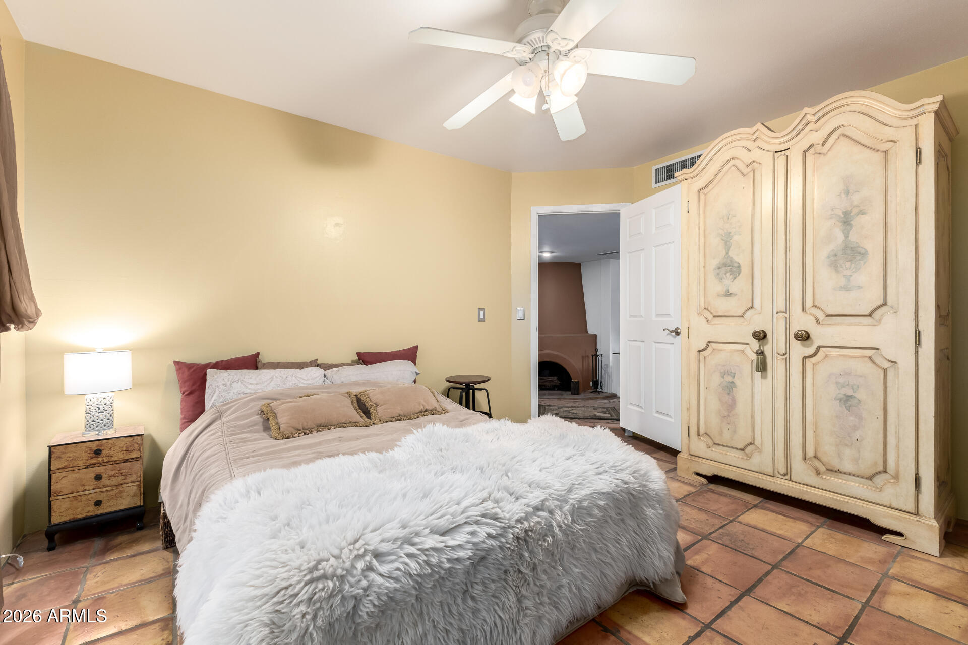 9012 South 47th Place Phoenix, AZ 85044 - Photo 28 of 54 a bedroom with a large bed and a chandelier