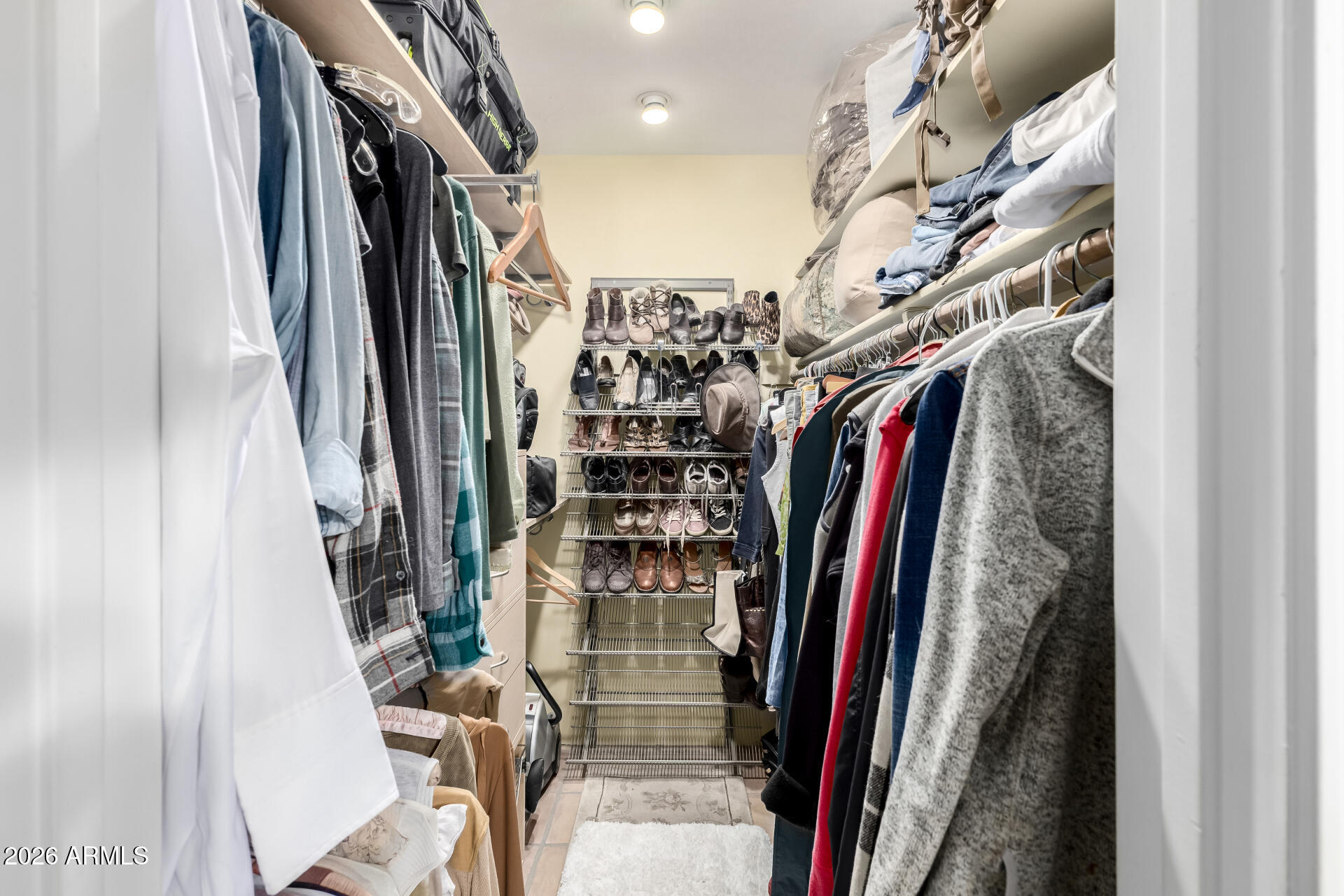 9012 South 47th Place Phoenix, AZ 85044 - Photo 36 of 54 a view of walk in closet with clothes and shoes
