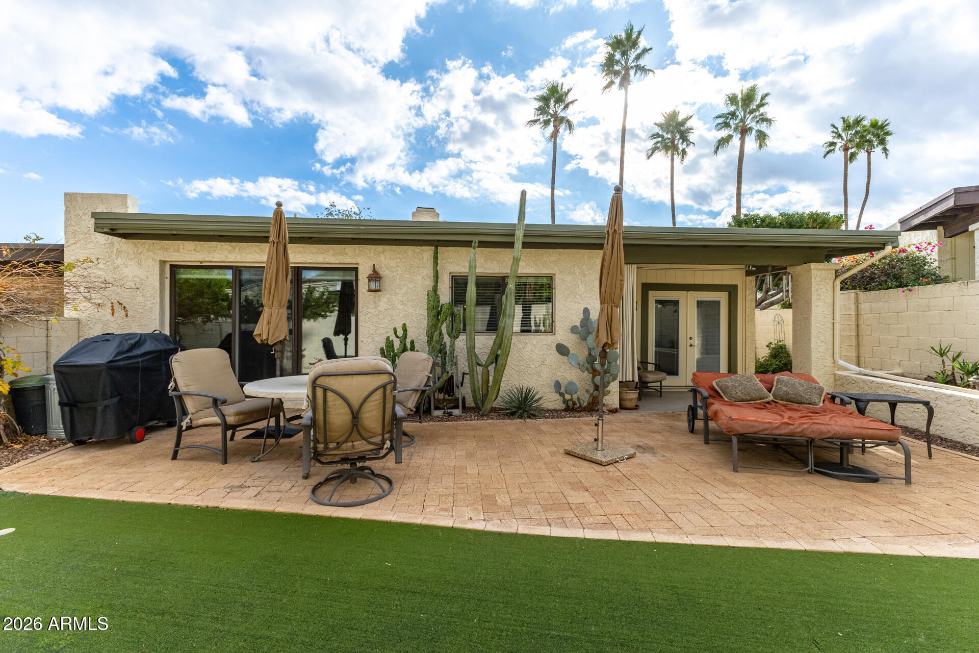 9012 South 47th Place Phoenix, AZ 85044 - Photo 51 of 54 a backyard of a house with yard table and chairs