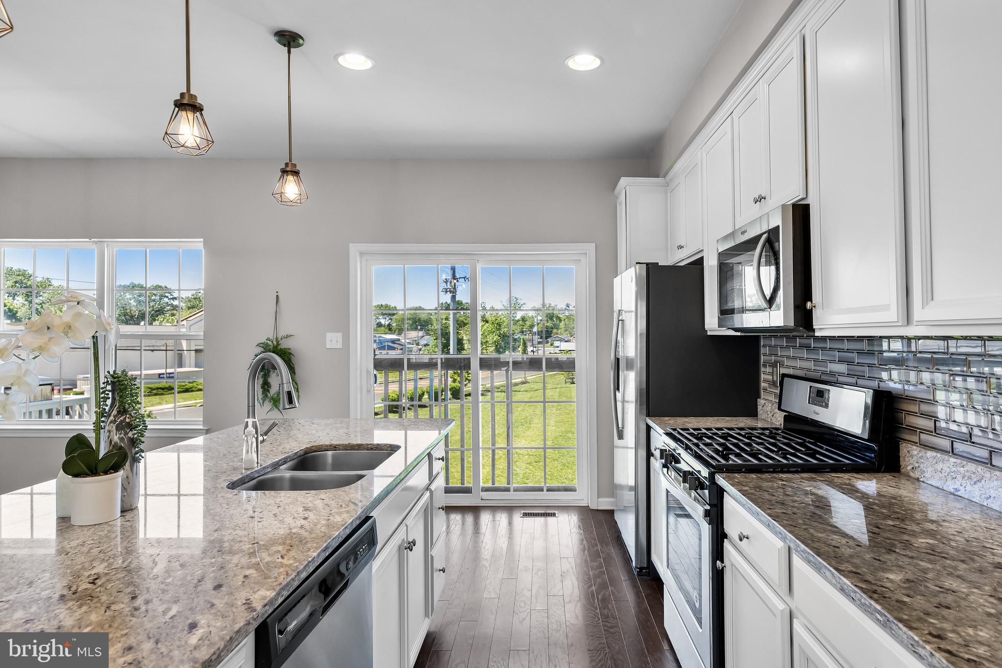 8 Iron Gate Road Sicklerville, NJ 08081 - Photo 13 of 33 a kitchen with stainless steel appliances granite countertop a sink a stove and a wooden cabinets