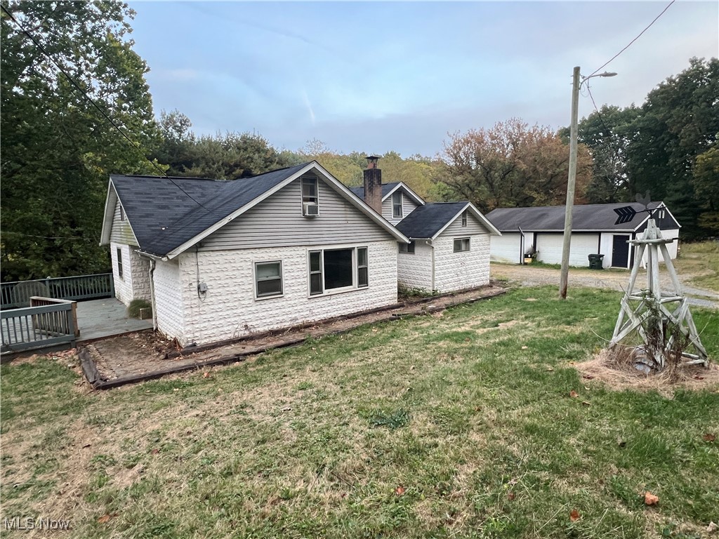 280 Holly Road Northwest Dellroy, OH 44620 - Photo 26 of 26 Rear view of house featuring a yard