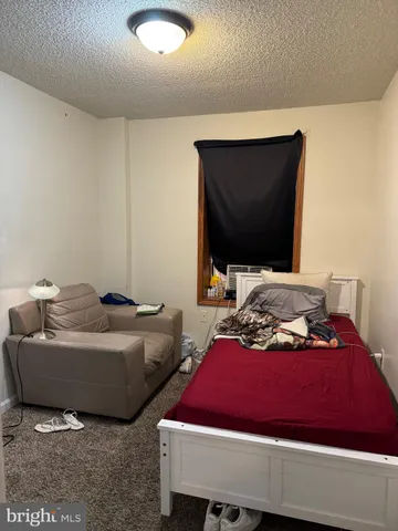 a bedroom with bed and a flat screen tv