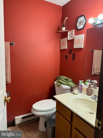 a bathroom with a sink mirror vanity and toilet