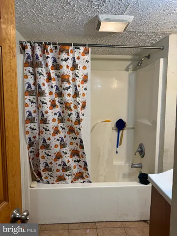 a bathroom with a bathtub and shower