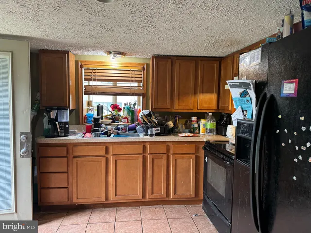 a kitchen with stainless steel appliances a refrigerator sink and cabinets