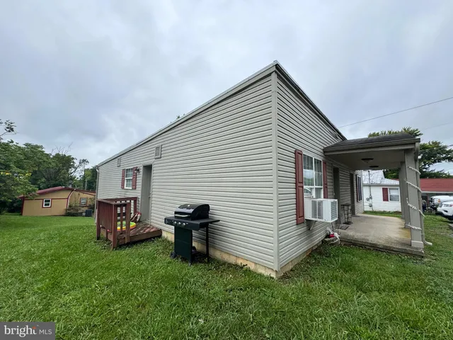 a view of a house with a yard and sitting area