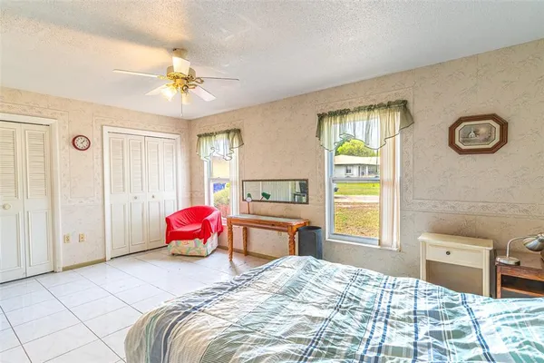 a bedroom with a bed dresser and window