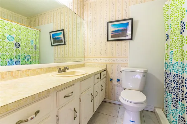 a bathroom with a toilet a sink and a window