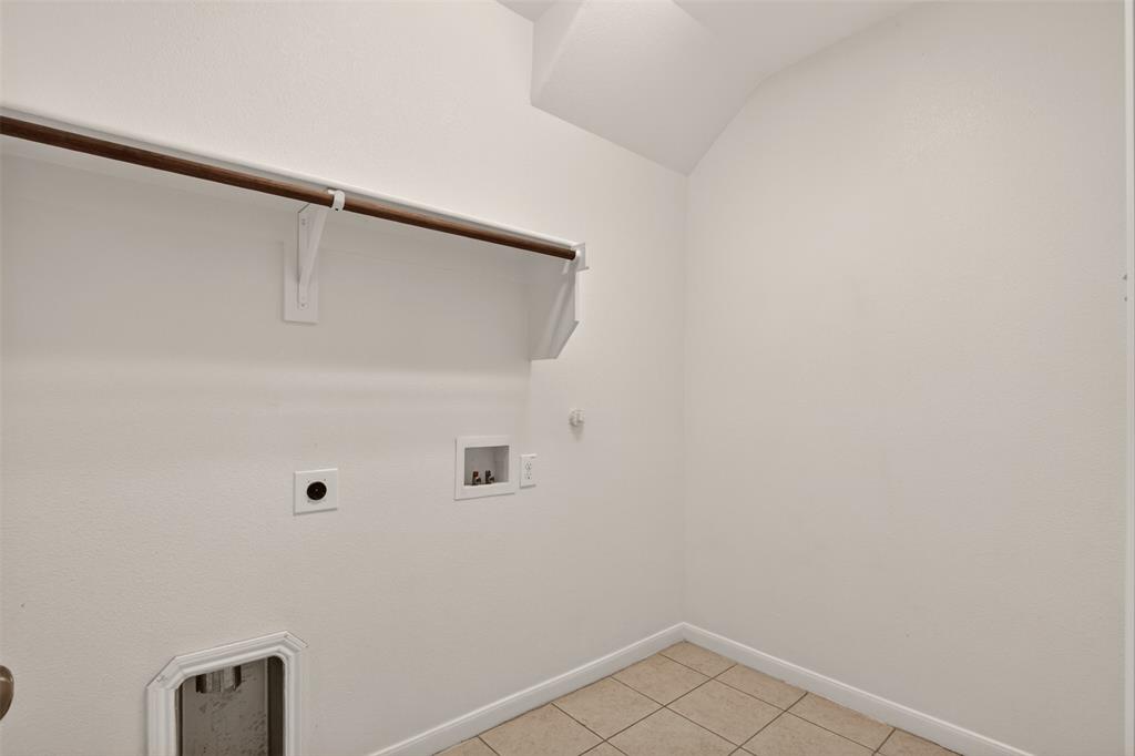 9105 Switchgrass Lane Forney, TX 75126 - Photo 8 of 20 Dedicated utility space featuring tile flooring, white walls, and a built-in hanging rod