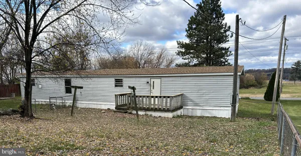 a view of a chairs and table in the backyard
