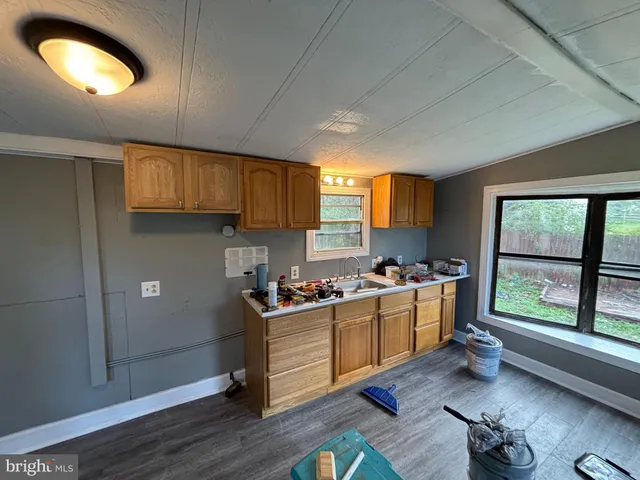 a kitchen with a stove a sink and a refrigerator
