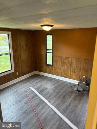 a view of a room with wooden floor and chair