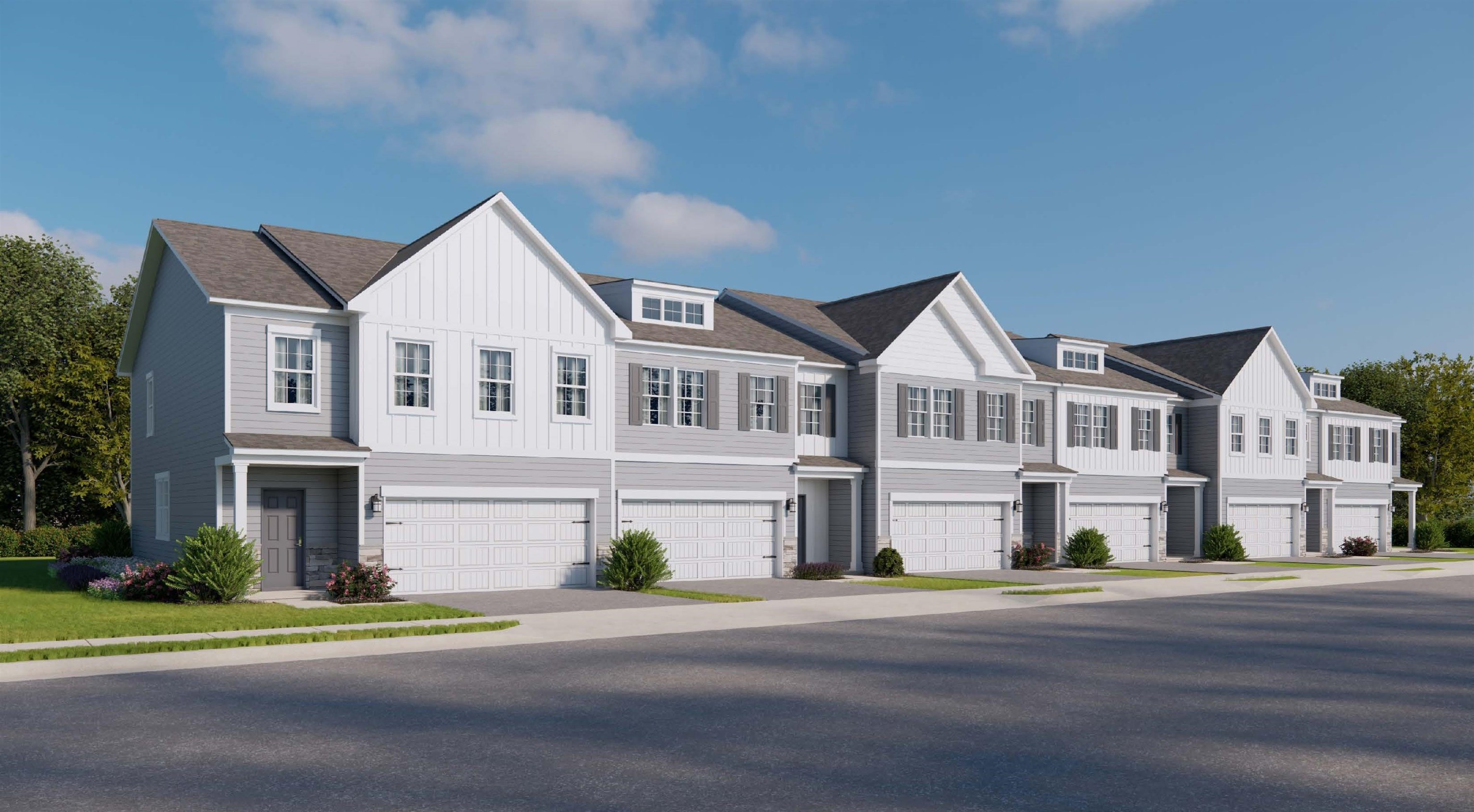 a front view of multiple houses with yard