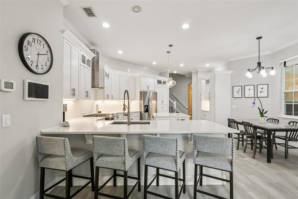 8350 Bowden Way Windermere, FL 34786 - Photo 17 of 45 a dining table chairs and a chandelier