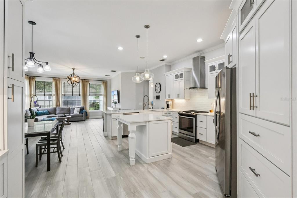 8350 Bowden Way Windermere, FL 34786 - Photo 18 of 45 a kitchen with stainless steel appliances a stove a sink dishwasher a refrigerator oven and white cabinets next to a window