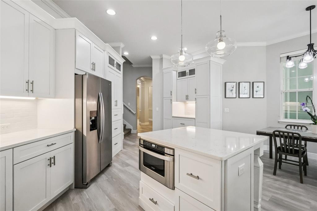8350 Bowden Way Windermere, FL 34786 - Photo 21 of 45 a kitchen with a table chairs refrigerator and microwave