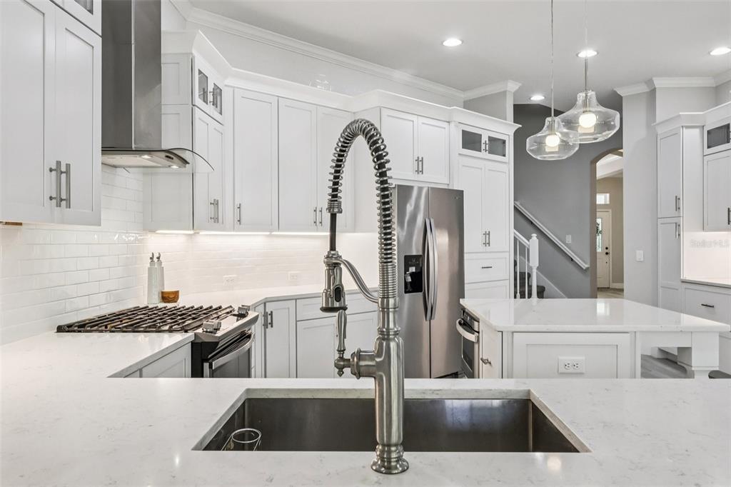8350 Bowden Way Windermere, FL 34786 - Photo 22 of 45 a kitchen with stainless steel appliances granite countertop a sink a counter space and cabinets