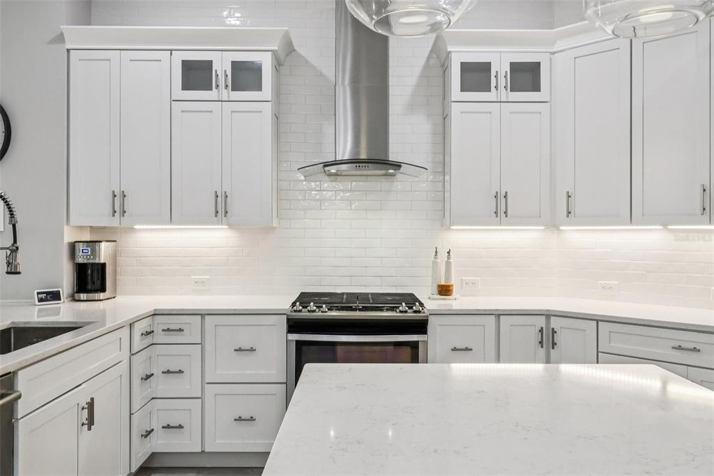 8350 Bowden Way Windermere, FL 34786 - Photo 23 of 45 a kitchen with granite countertop white cabinets and appliances