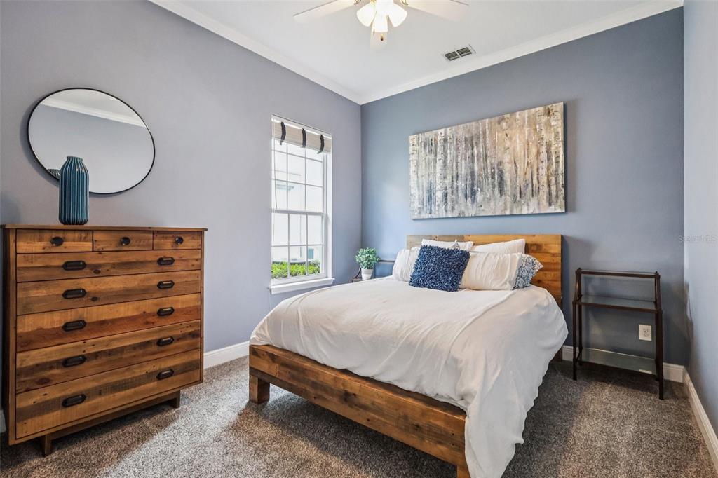 8350 Bowden Way Windermere, FL 34786 - Photo 29 of 45 a bedroom with a bed and a chandelier