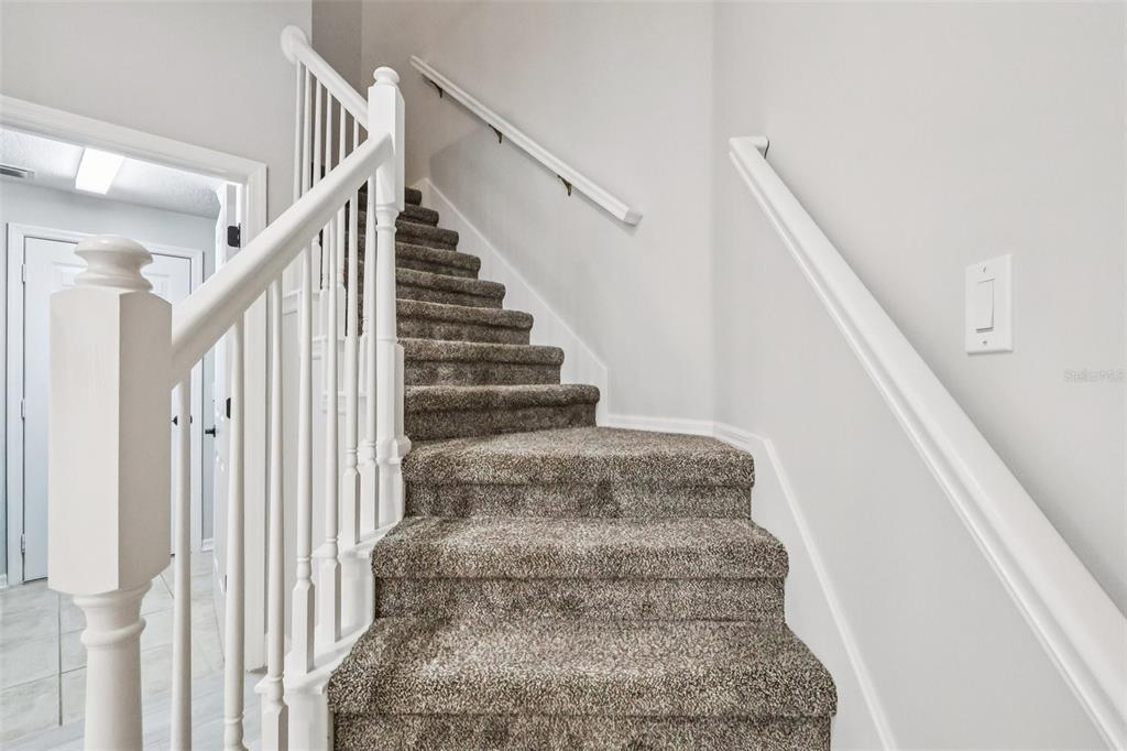 8350 Bowden Way Windermere, FL 34786 - Photo 34 of 45 a view of staircase with white walls and white walls