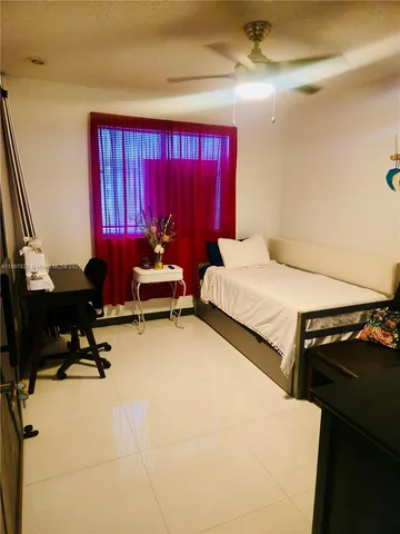 a bedroom with furniture and a window