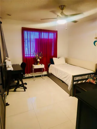 a bedroom with furniture and a window