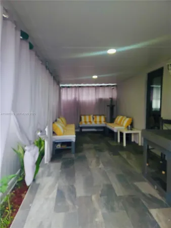 a living room with furniture and a lamp