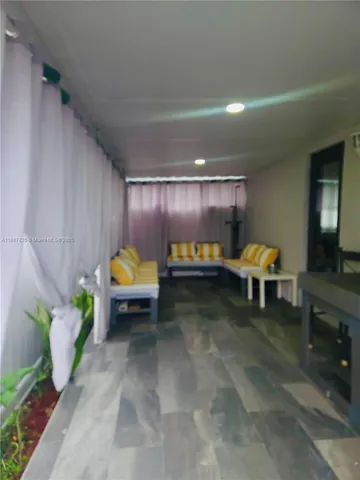 a living room with furniture and a lamp