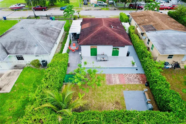 an aerial view of a house with a garden and plants