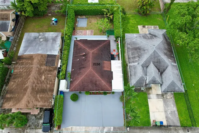 an aerial view of a house with yard swimming pool and outdoor seating