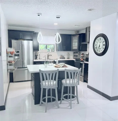 a dining room with a wooden table and chairs