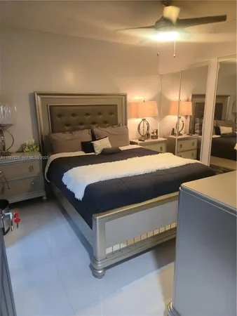 a bedroom with a bed and a mirror