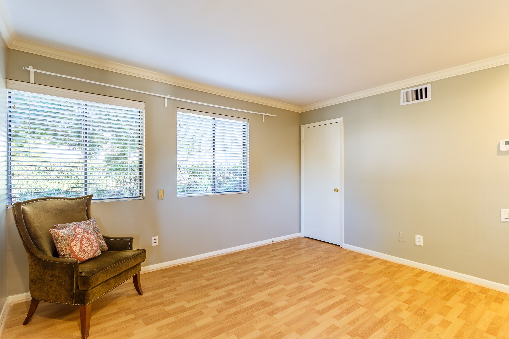 2349 Albans Road, Unit 1 Houston, TX 77005 - Photo 3 of 14 Living room with light wood flooring, neutral walls, and large windows with blinds.