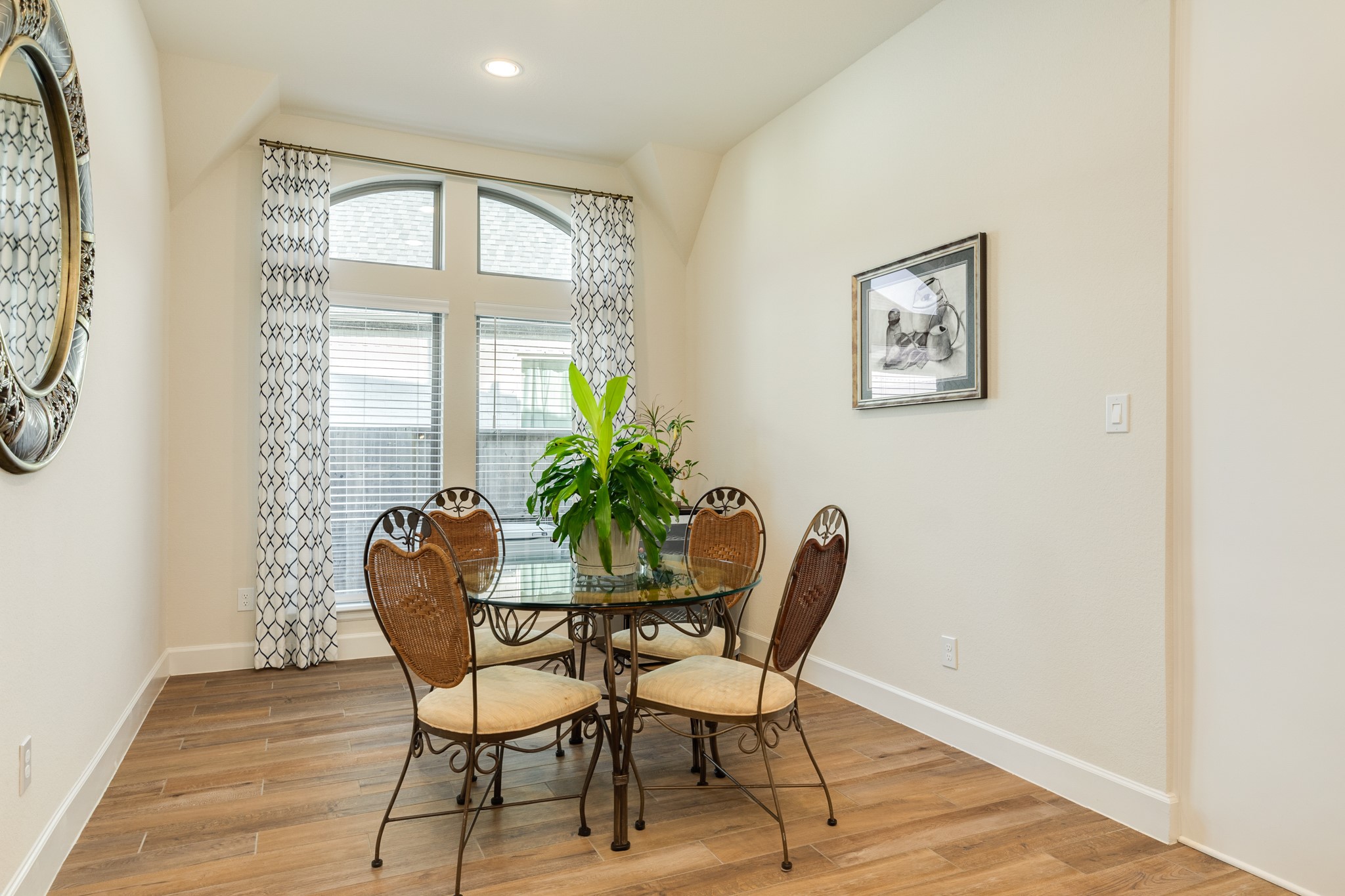 9538 Sanger Way Manvel, TX 77578 - Photo 19 of 50 The breakfast nook is conveniently located adjacent to the kitchen, featuring two large windows and recessed lighting, making it an ideal space for enjoying your morning beverage