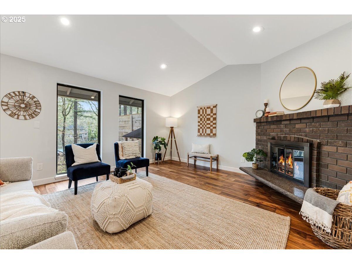 4268 Woodside Circle Lake Oswego, OR 97035 - Photo 14 of 44 a living room with furniture large window and a fireplace