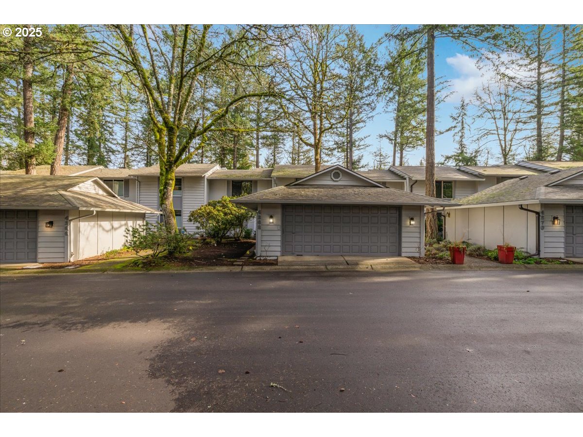4268 Woodside Circle Lake Oswego, OR 97035 - Photo 35 of 44 a front view of a house with a yard and garage