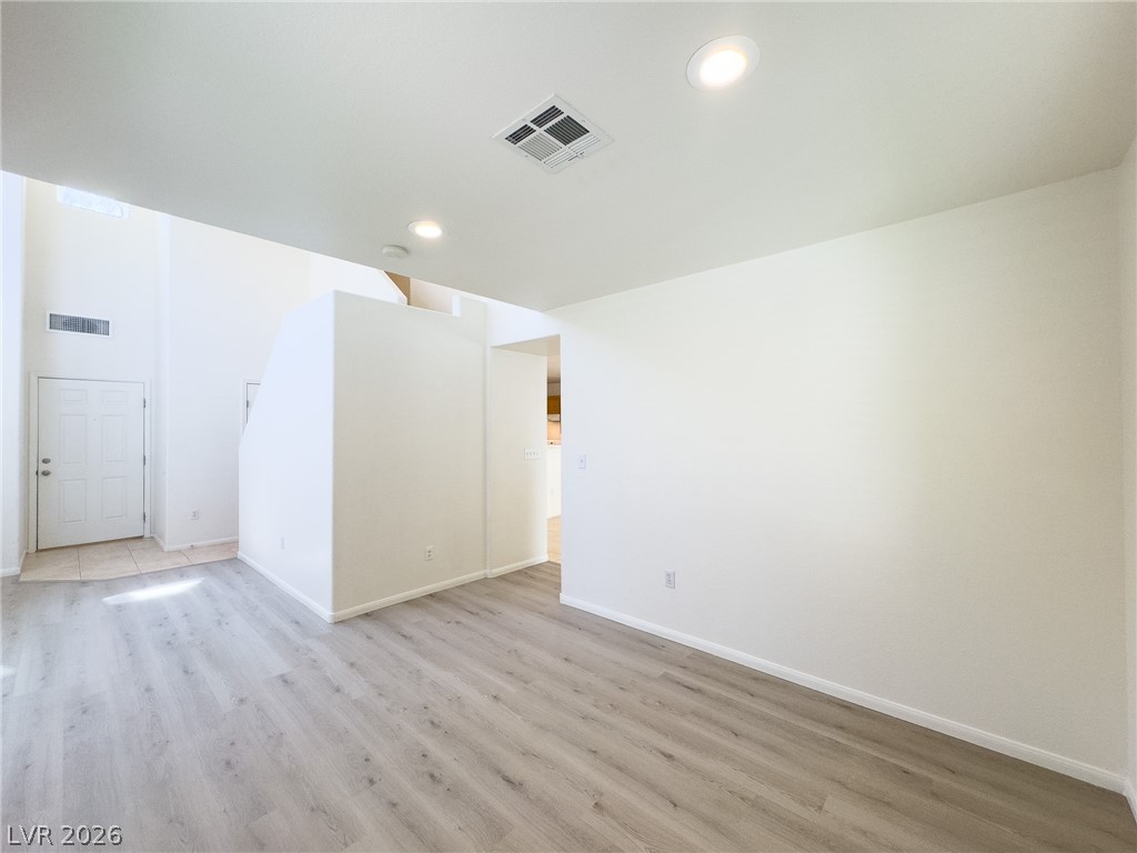 9456 Grandview Spring Avenue Las Vegas, NV 89166 - Photo 49 of 49 An open floorplan features recessed lighting and durable wood flooring.