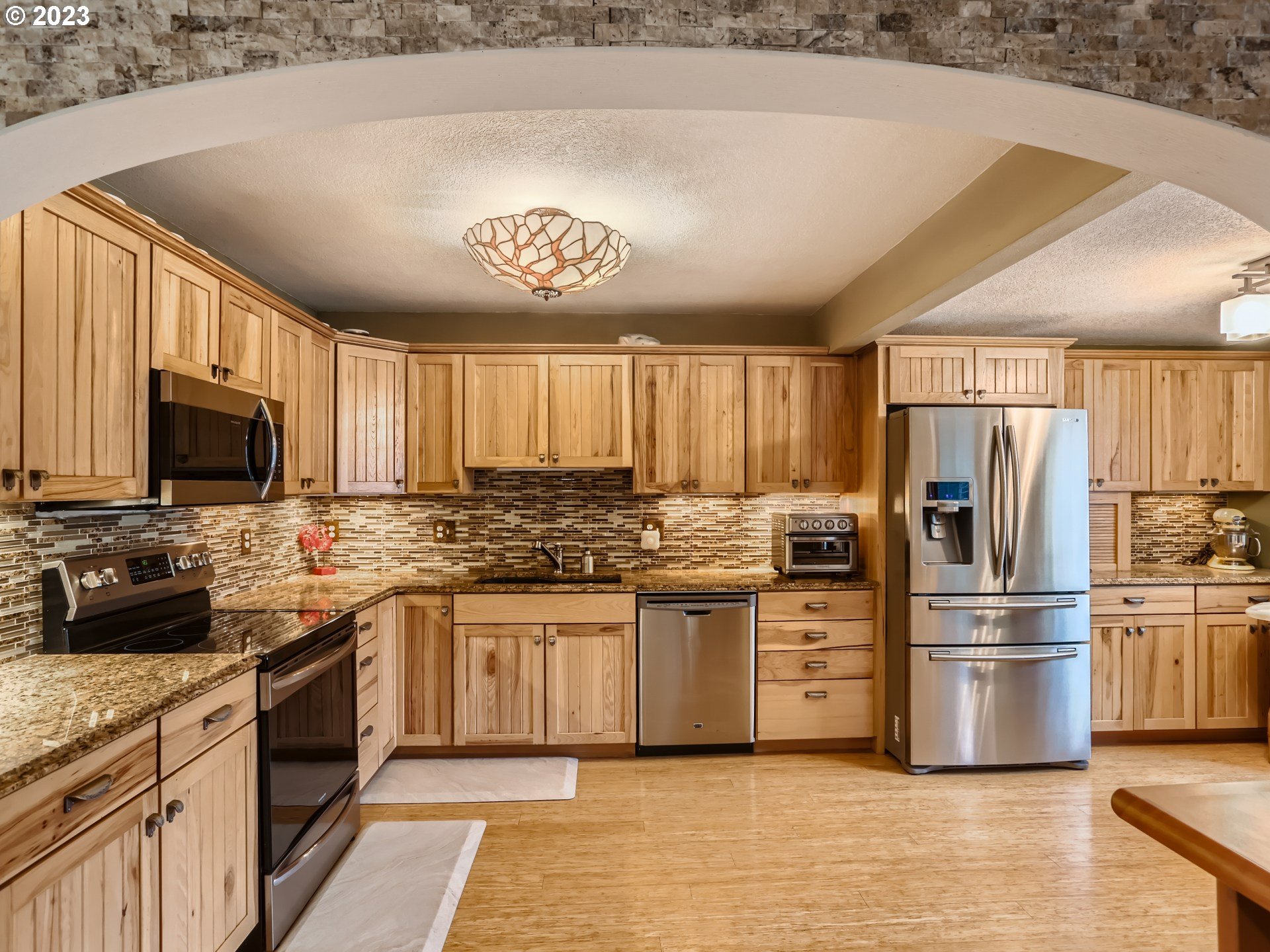 13611 South Union Hall Road Canby, OR 97013 - Photo 8 of 29 a kitchen with stainless steel appliances a stove refrigerator sink and microwave
