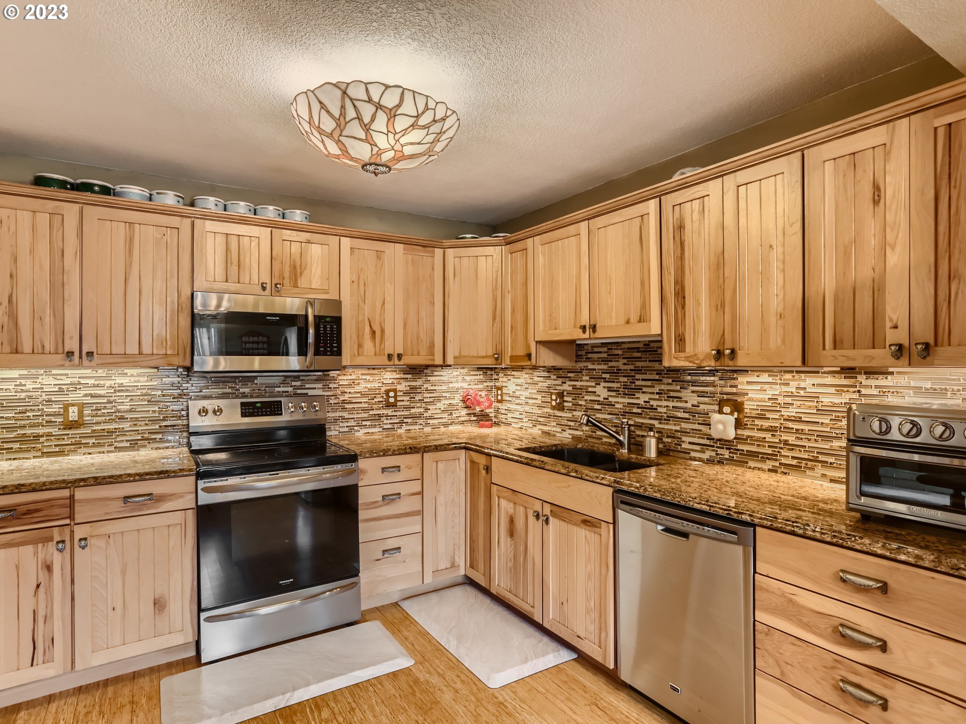 13611 South Union Hall Road Canby, OR 97013 - Photo 10 of 29 a kitchen with stainless steel appliances granite countertop a stove sink microwave and cabinets