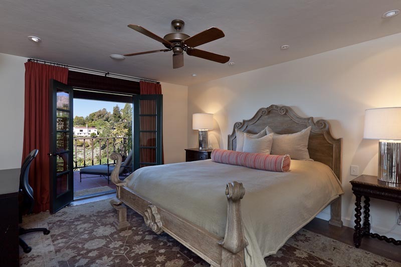 1021 Las Alturas Road Santa Barbara, CA 93103 - Photo 8 of 20 a bedroom with a bed a ceiling fan and a large window