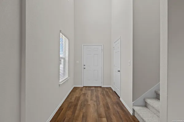 a view of a room with wooden floor and window
