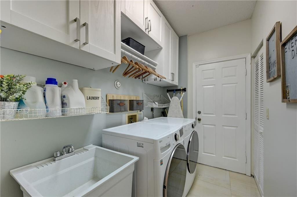 8171 Hampton Wood Drive Boca Raton, FL 33433 - Photo 52 of 56 a utility room with cabinets washer and dryer